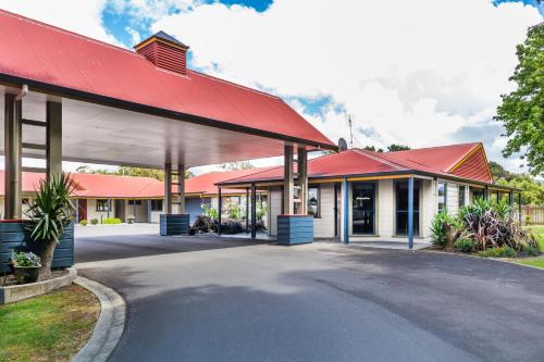 an image of a building with a red roof at ASURE Oak Estate Motor Lodge in Greytown