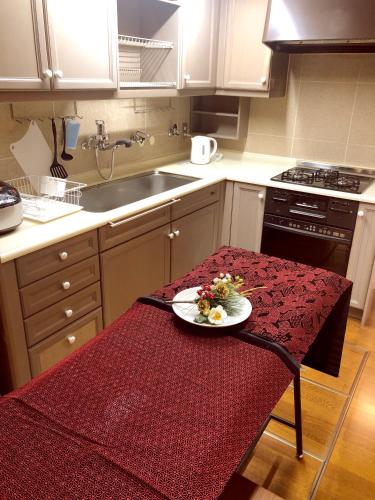 a kitchen with a table with a plate on it at Guest room Kamakura Nagomi -Camellia- in Kamakura