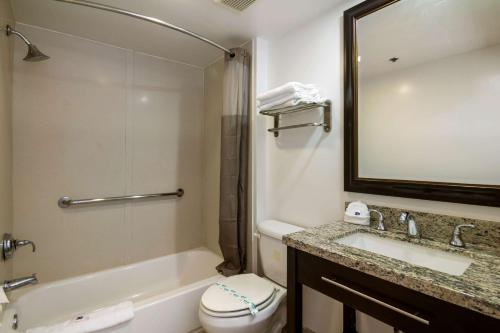 a bathroom with a sink and a toilet and a mirror at Motel 6 Monterey Park in Monterey Park