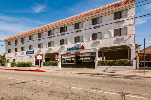 a large building with a mobil gas station on a street at Motel 6 Monterey Park in Monterey Park