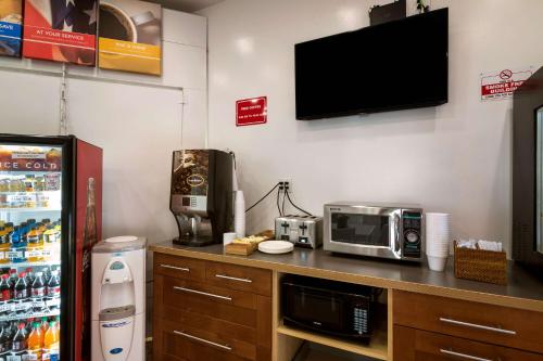 a kitchen with a microwave and a tv on a counter at Motel 6 Monterey Park in Monterey Park