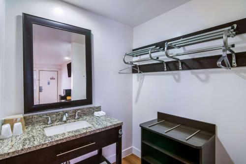 a bathroom with a sink and a mirror at Motel 6 Monterey Park in Monterey Park