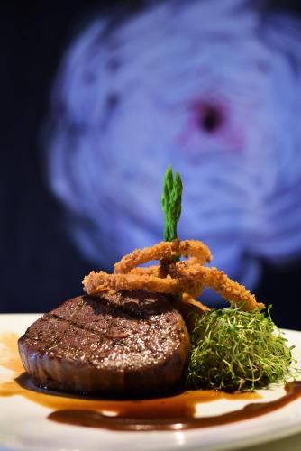a piece of steak on a plate with brown sauce at Mercure Selangor Selayang in Batu Caves