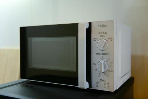 a microwave oven sitting on top of a table at Nishioji TANUKI in Kyoto