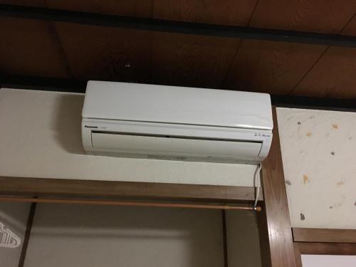 a white printer sitting on top of a shelf at Guest House YAMASHITA-YA in Nanto