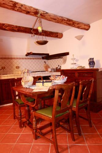 a kitchen with a wooden table and chairs at Residenza La Torre in Santo Stefano di Sessanio