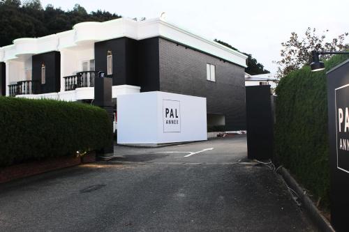 a building with a parking lot with a garage at Pal Annex Munakata (Love Hotel) in Munakata