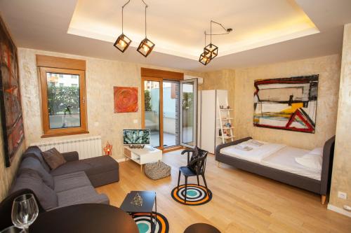 a living room with a couch and a bed at Gentleman Dog Apartment in Belgrade
