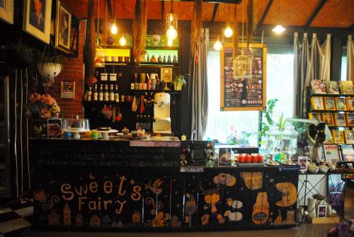 a store with a counter in a room at Pupiang po Da Arte Resort in Dan Sai
