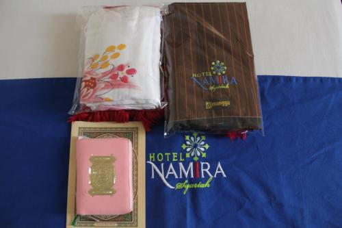 three awards on top of a blue blanket at Hotel Namira Syariah Pekalongan in Pekalongan