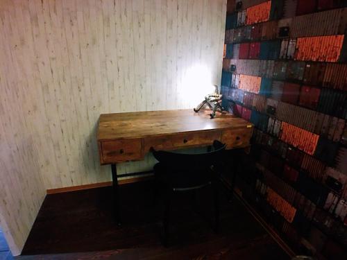 a wooden desk in a room with a chair at Love Hotel in Taipei