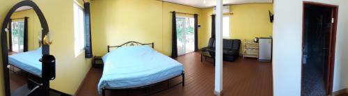 a room with two beds and a tv in it at Elephant & Castle in Ko Chang