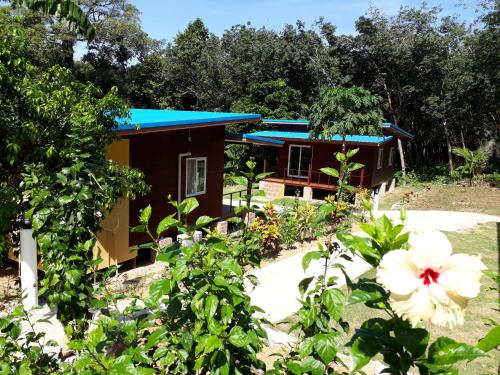 a house with a blue roof and a garden at Elephant & Castle in Ko Chang