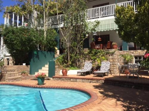 a swimming pool in front of a house at Edenwood House in George