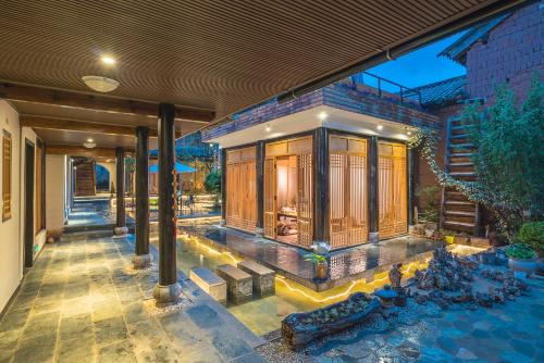 an external view of a house with a swimming pool at Dali Shaxi Qing Jing Courtyard in Jianchuan