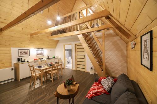 a living room and kitchen in a log cabin at Górski Szałas in Zakopane