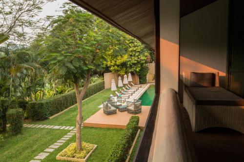 a view of the garden from the balcony of a house at The Apsara Rive Droite in Luang Prabang