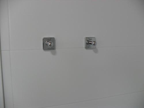 a bathroom with two speakers on a white wall at Hotel Lo Monte in Pilar de la Horadada