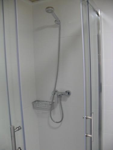 a shower with a shower head on a wall at Hotel Lo Monte in Pilar de la Horadada