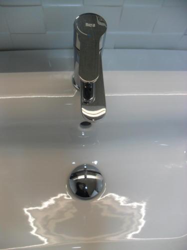 a sink with a faucet in a white sink at Hotel Lo Monte in Pilar de la Horadada