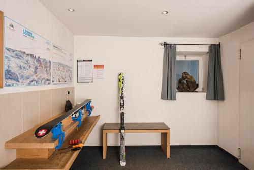 a room with a table and skis on a wall at Hotel Royal in Sesto