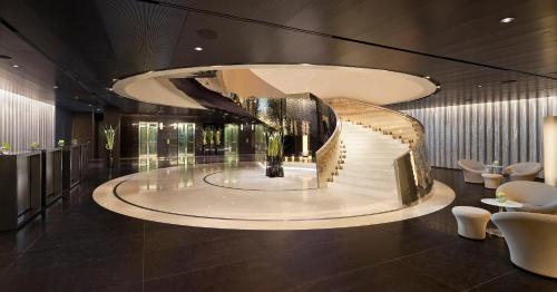 a lobby with a spiral staircase in a building at Melia Vienna in Vienna