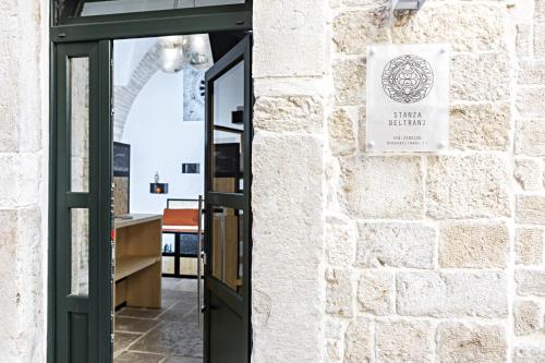 a door to a building with a sign on it at BORGOBELTRANI in Trani