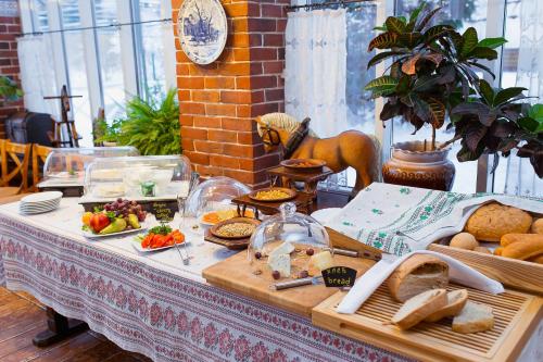a table topped with lots of different types of food at Konyushenny Dvor Guest House in Ryazan