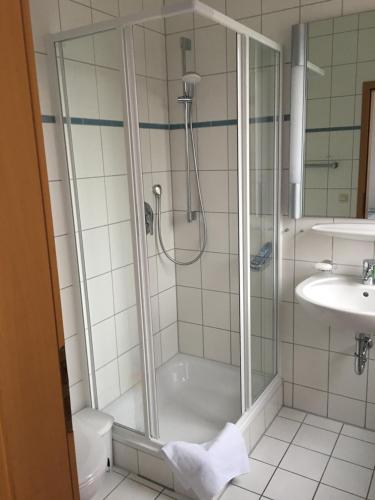 a bathroom with a shower and a toilet and a sink at Jimmy Gastronomie & Übernachtung in Altheim