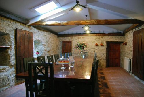 a dining room with a wooden table and chairs at Quinta Casa da Fonte in Vieira do Minho