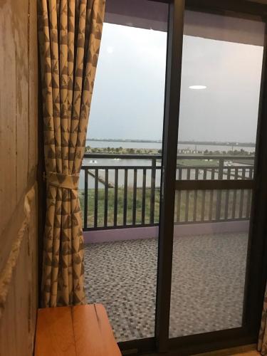 a sliding glass door with a view of a balcony at Relaxing Hotel in Donggang