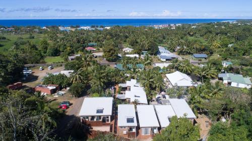 an aerial view of a village with palm trees and the ocean at Kia Orana Villas and Spa in Rarotonga