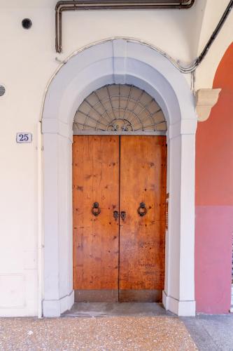 an entrance to a building with a wooden door at BolognaRoomscom - Isaia Garden Private Garden Spa Bath in Bologna