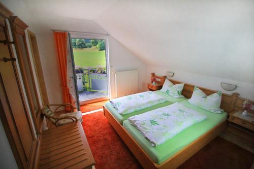 a bedroom with a bed and a large window at Gästehaus Ursula in Hornberg