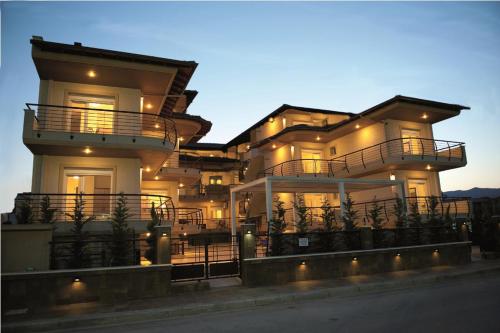 a large building with lights on the side of it at Rodolithos Beach Studios in Stavros