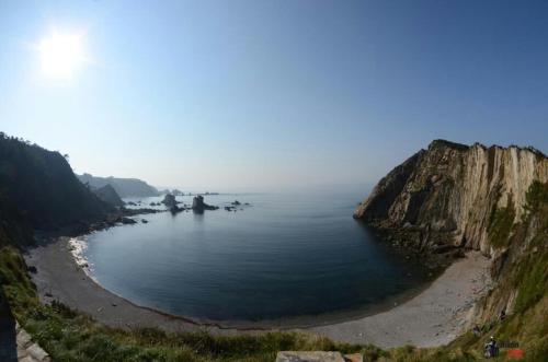 a large body of water next to a cliff at Hotel Valle Las Luiñas in Soto de Luiña