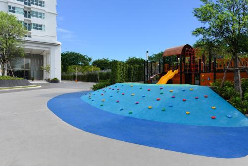 a playground with a slide in a playground at Centre Point Prime Hotel Pattaya in Pattaya North