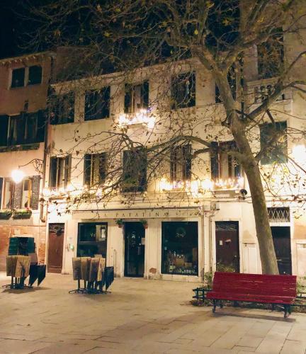 a red bench sitting in front of a building at B&B Patatina in Venice