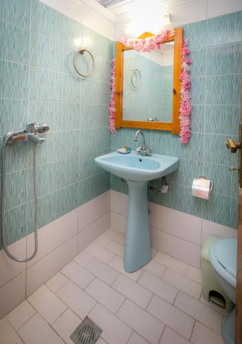 a bathroom with a sink and a shower with a mirror at Apartment Evaggelia Sea View in Skala Marion