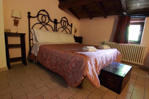 a bedroom with a large bed and a window at Residenza La Torre in Santo Stefano di Sessanio