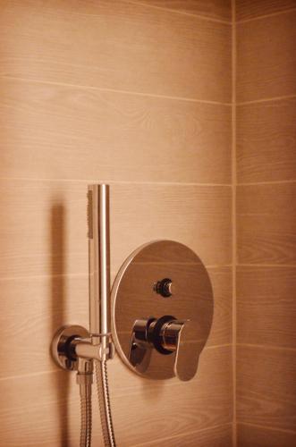 a shower stall with a shower head and a shower at Punto8 in Trieste