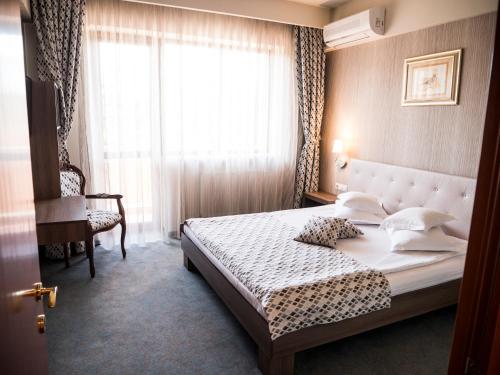 a hotel room with a bed and a window at Best Western Silva Hotel in Sibiu