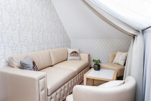 a living room with a couch and a table at Родичі in Zhashkiv