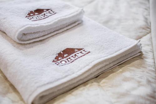 two towels sitting on top of a bed at Родичі in Zhashkiv