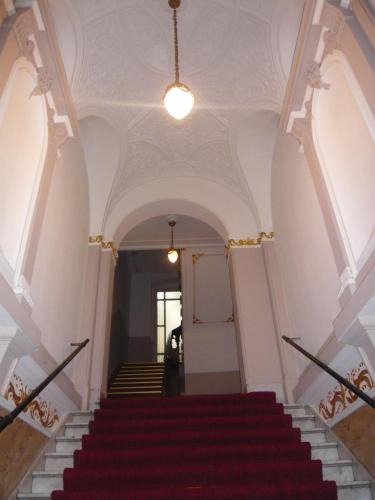 a staircase in a building with a red carpet at Hotel Gunia in Berlin