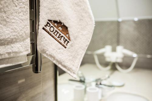 a towel hanging on a towel rack in a bathroom at Родичі in Zhashkiv