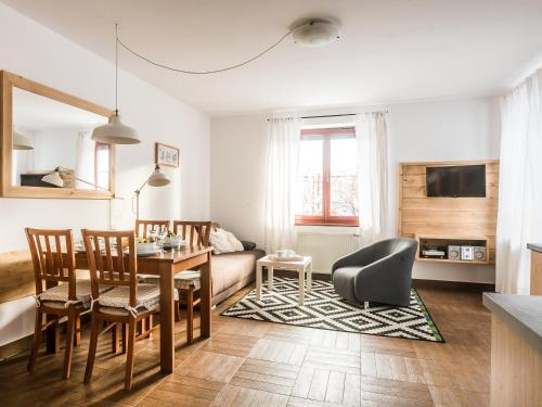 a living room with a table and chairs and a dining room at TatryTop Pod Lipkami in Zakopane