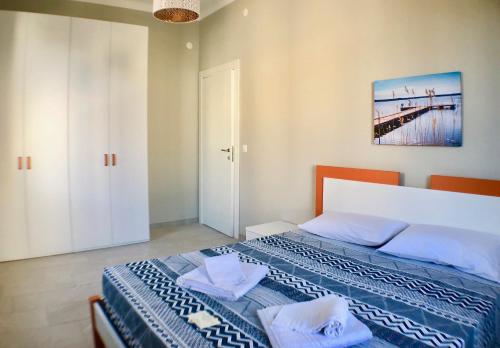 a bedroom with a bed with a blue and white blanket at Maraini Apartments by Quokka 360 - strategic location near Lugano station in Lugano