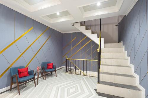 a staircase with two chairs and a table and a stair case at RedDoorz near IPB Dramaga Bogor in Bogor