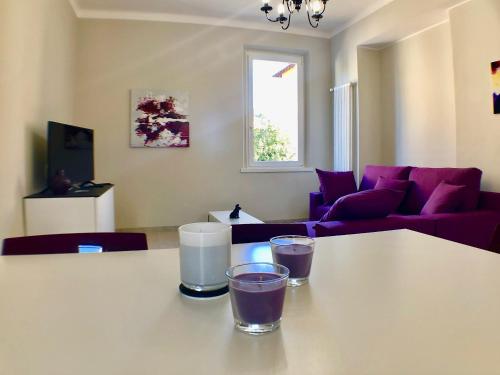 a living room with a table with two glasses on it at Maraini Apartments by Quokka 360 - strategic location near Lugano station in Lugano